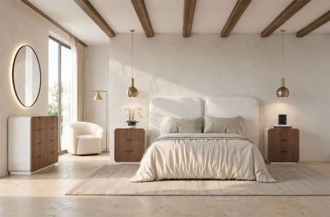 Dormitorio contemporáneo con cama de cabecero tapizado curvo, mesillas de madera con cantos redondeados, cómoda o consola a juego, espejo ovalado iluminado y decoración en tonos naturales